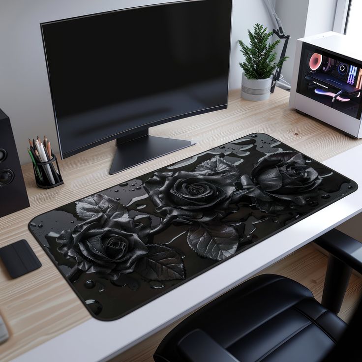 a computer desk with a monitor, keyboard and mouse pad on top of the desk