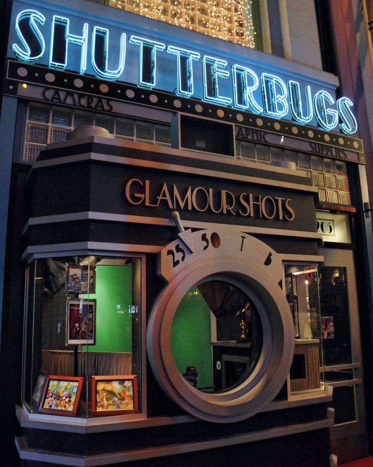 a store front with the word glamous shots on it's display window