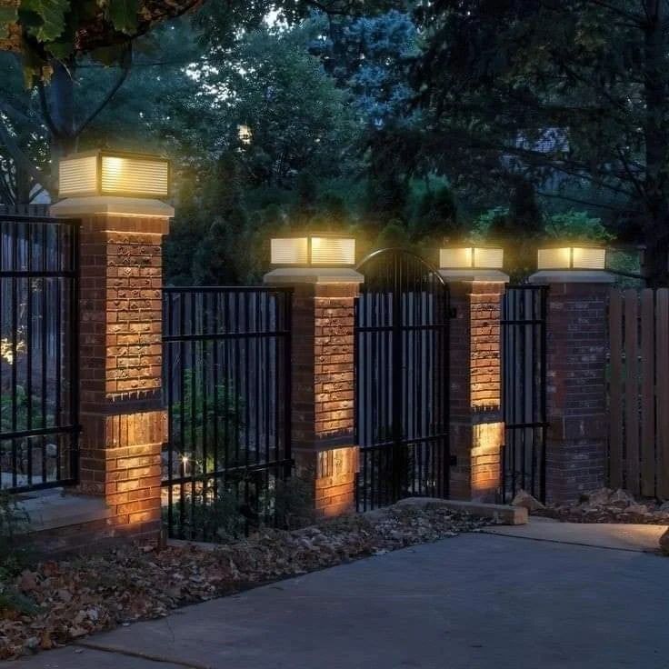 an iron fence with three lights on it