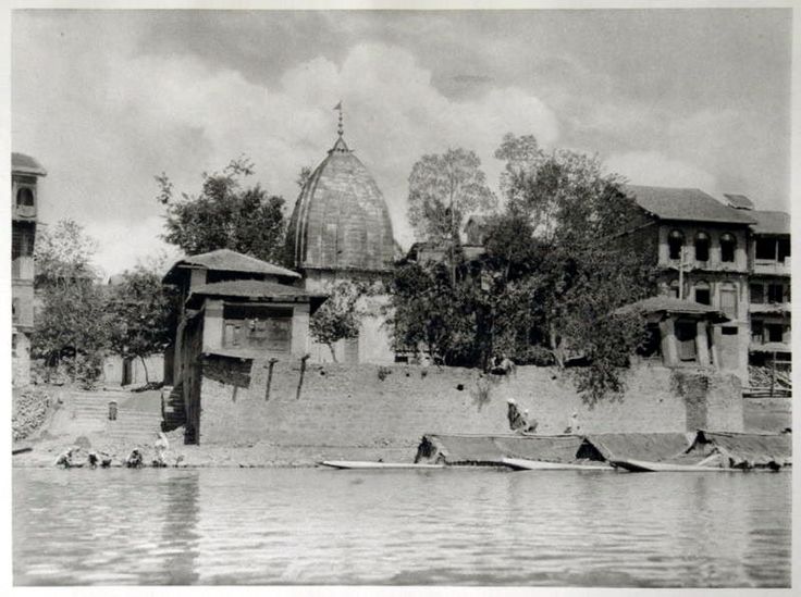 an old black and white photo of people in the water near a building with a dome on top