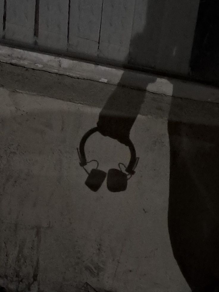 the shadow of a person with headphones on