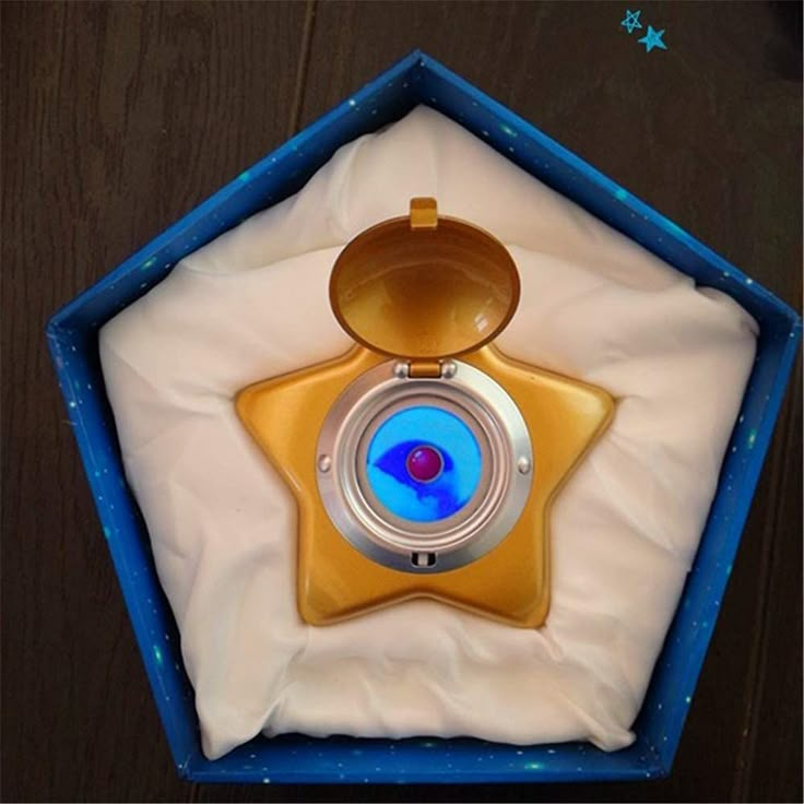 a blue and gold star shaped object in a box