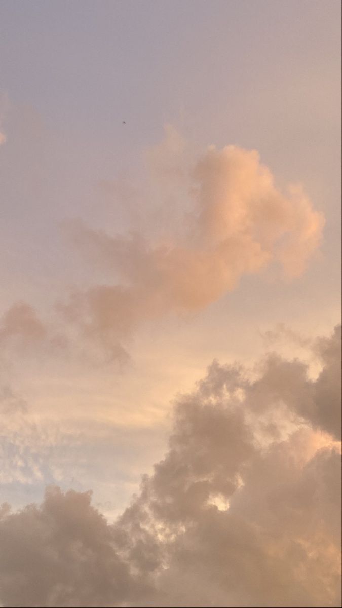 an airplane is flying high in the sky with some clouds behind it and one plane has just taken off