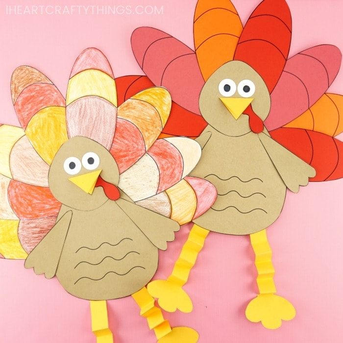 two turkeys made out of construction paper on a pink background with the words thanksgiving written in large letters