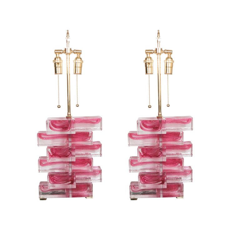 pair of pink glass and brass chandeliers