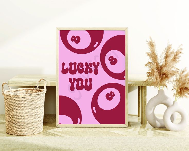 a pink poster with the words lucky you next to two vases and a basket