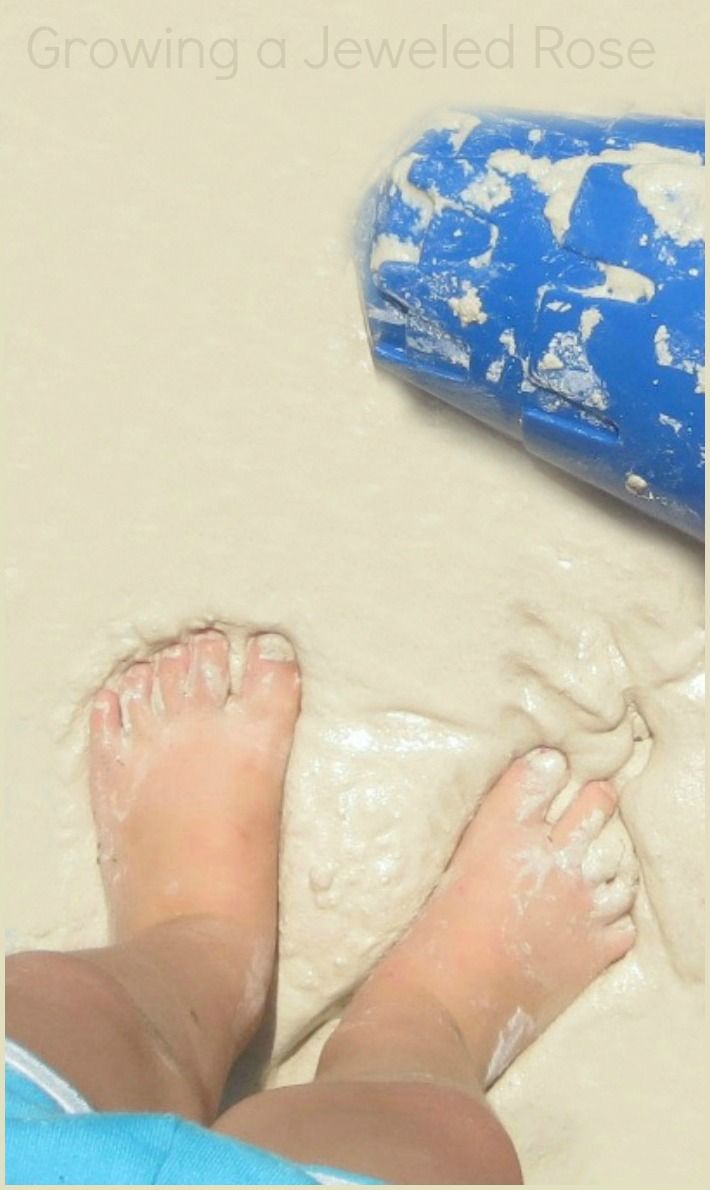 a person laying on top of a bed next to a blue and white object with the words quicksand