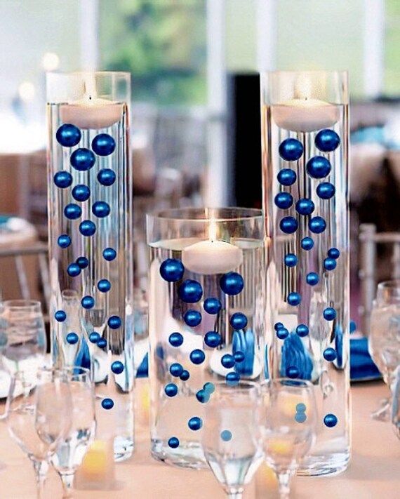 a table topped with lots of glasses and candles