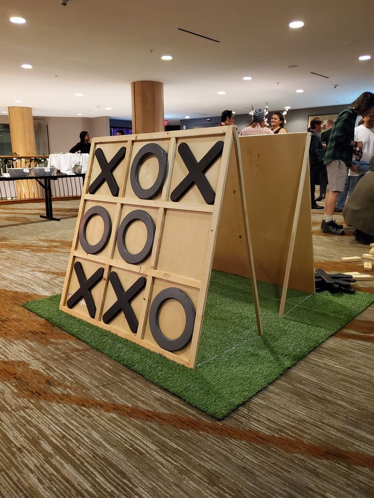 a tic - tac - toe board on the ground in an airport lobby