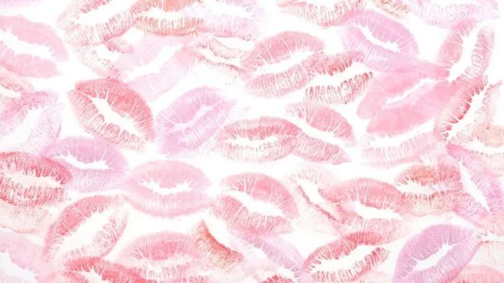 pink lipstick kisses on a white background with red and pink highlights in the middle, all over