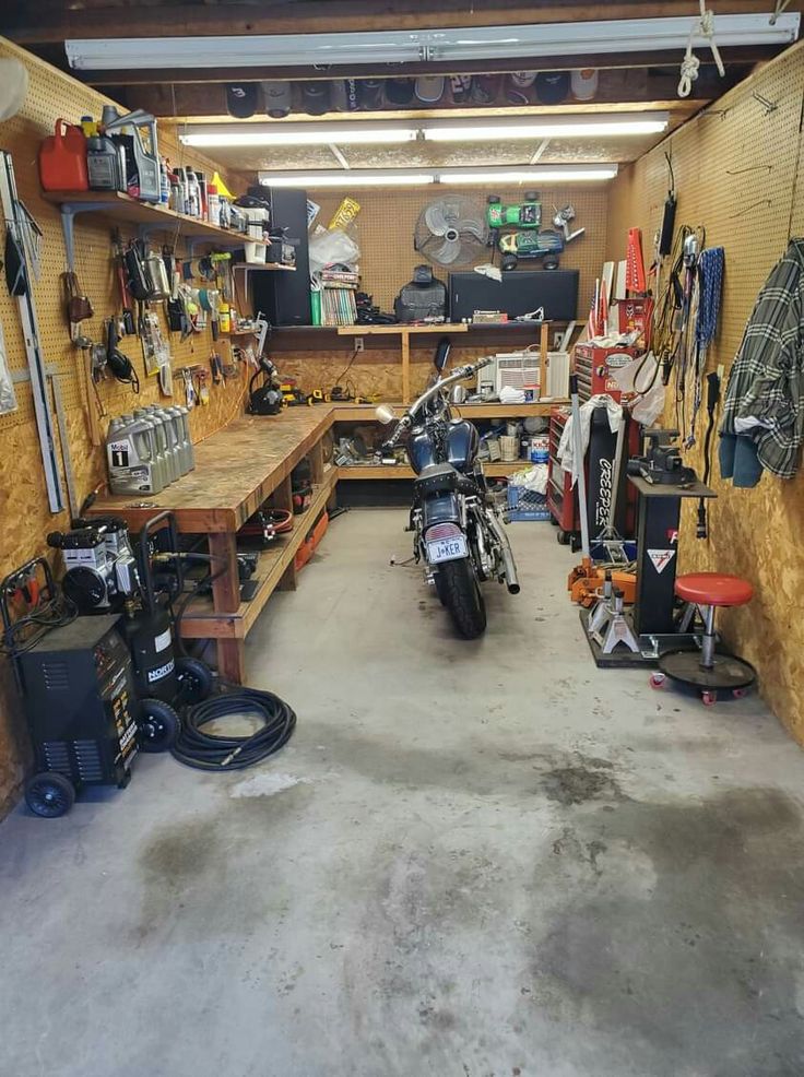 a garage filled with lots of tools and equipment on the wall next to each other