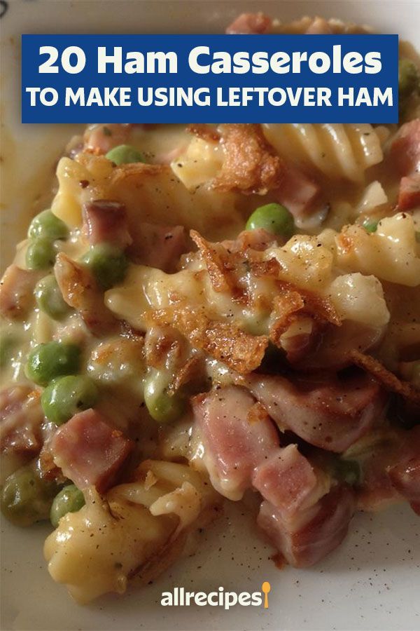 a white plate topped with pasta covered in ham and peas on top of it's side