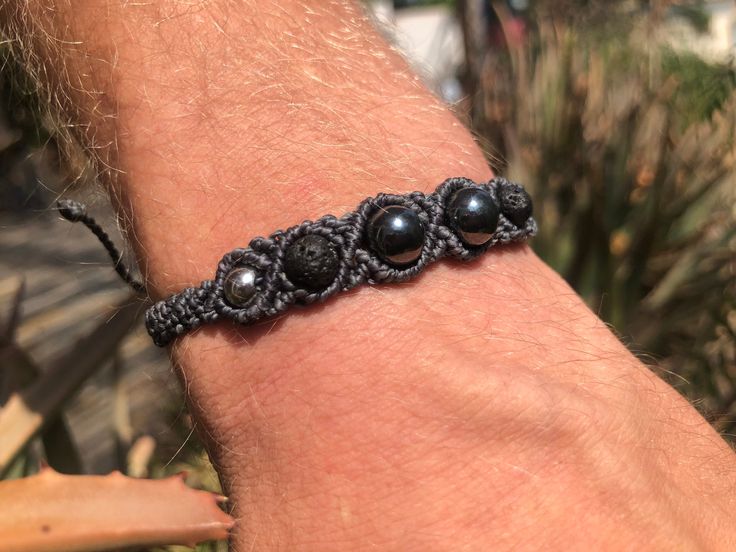 ♦️ Men's gemstone bracelet, hematite, black lava stone, and stainless steel beaded macrame bracelet for him. Choose your color cord. Men's macrame bracelets made and designed by Psychedelic Macrames ॐ ∇ Each piece of jewelry is made with attention to all details, love, and lots of positive energies. This macrame bracelet has a 26 cm adjustable cord. The sliding knot makes it wearable to standard sizes.   Contact me at any time for custom or special orders. ॐ ॐ ॐ Find here matching gemstone neckl Adjustable Hematite Bracelets, Stone Macrame, Amulets And Talismans, Bracelet For Him, Statement Bracelets, Urban Jewelry, Vegan Jewelry, Lava Stone Bracelet, Bracelet Stone