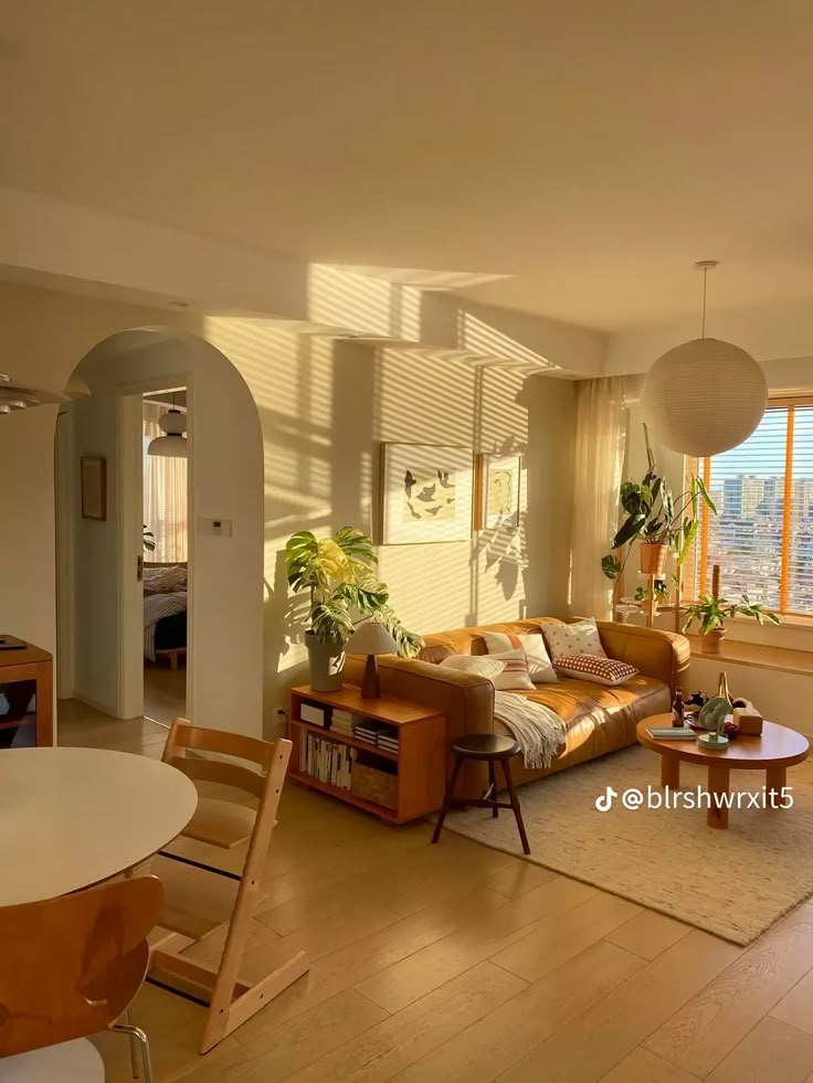 a living room filled with furniture and lots of windows