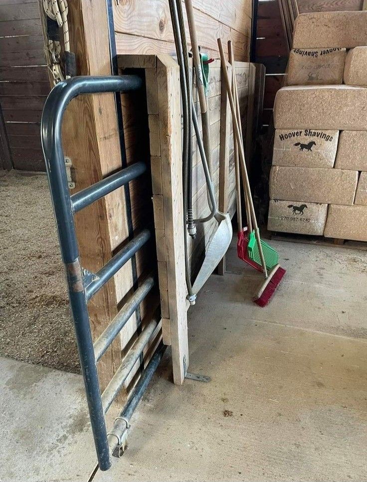 a pile of boxes and brooms sitting next to each other in a storage room