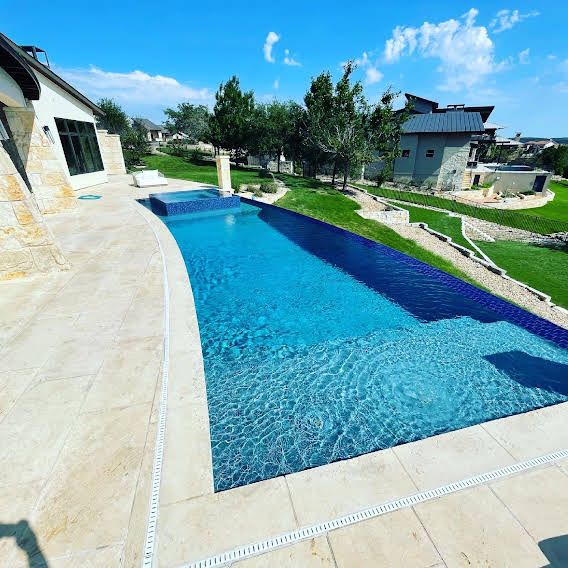 an empty swimming pool in the middle of a yard