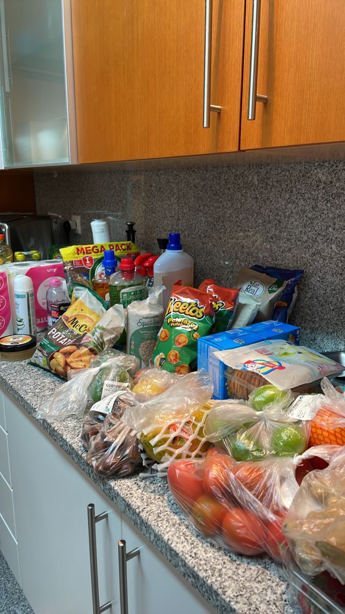 a kitchen counter covered in lots of food