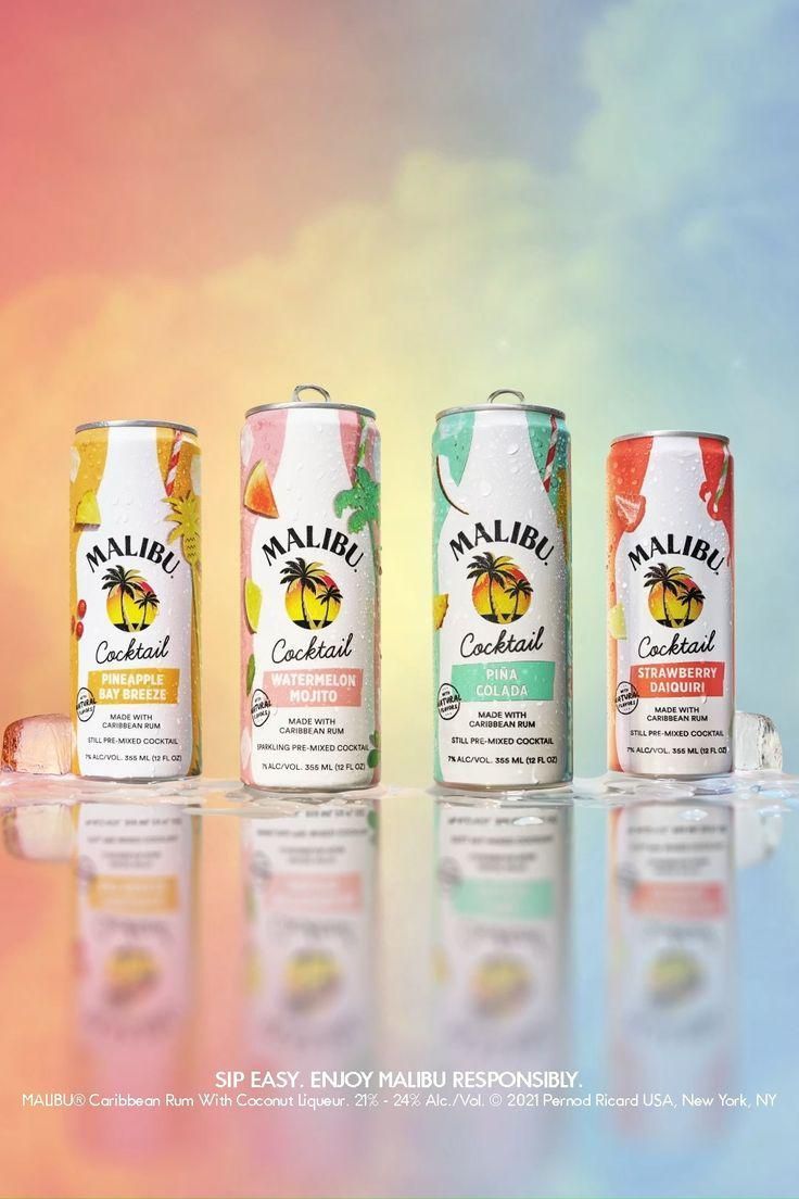 three cans of tropical flavored drink on a colorful background with the caption's name