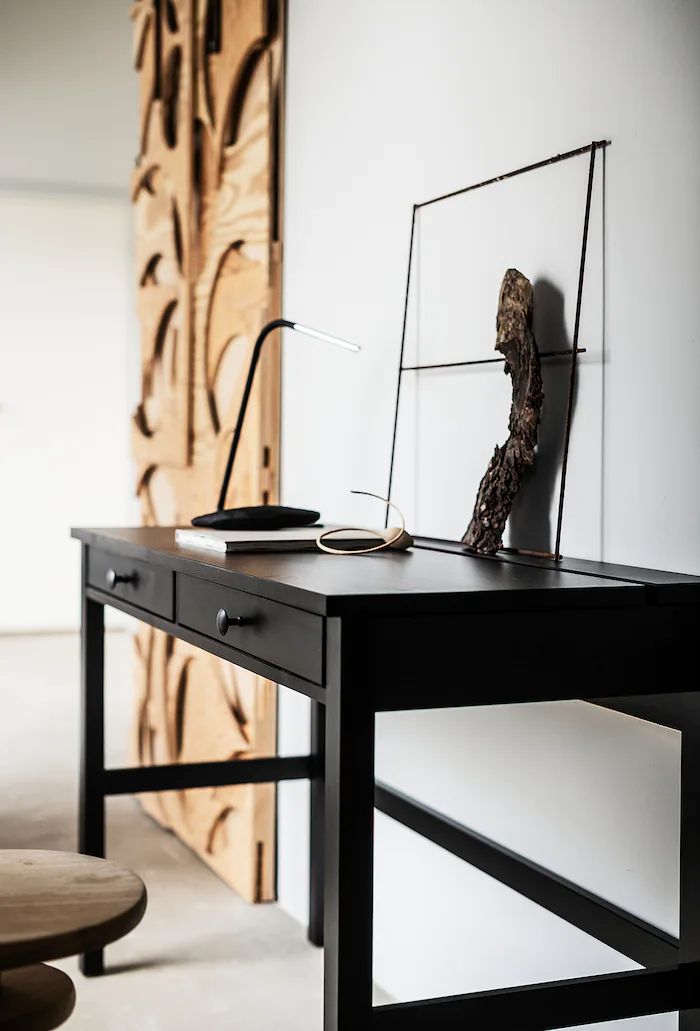 a desk with a sculpture on top of it