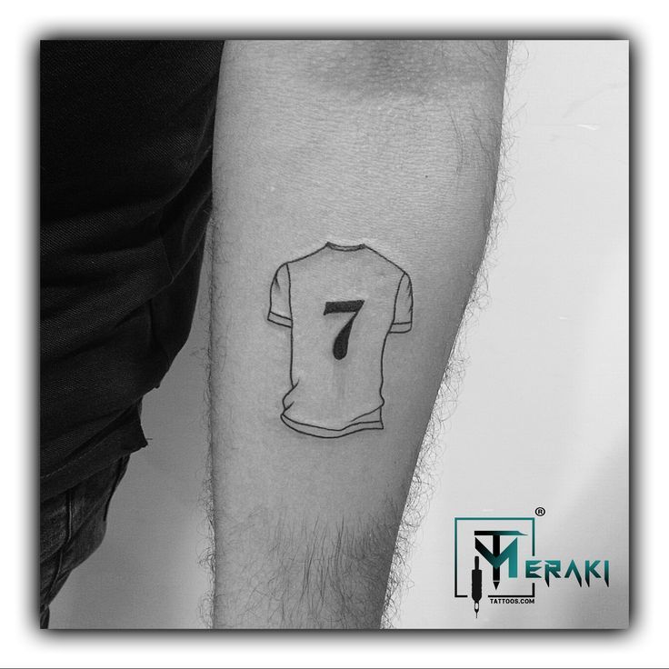 a black and white photo of a man's arm with a t - shirt on it