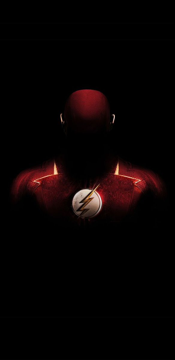 the flash standing in front of a black background