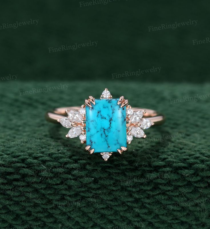 a turquoise stone and diamond ring on top of a green blanket with the words, i love