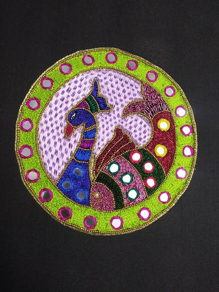 an embroidered patch with two horses in the center on a black background, surrounded by circles and dots