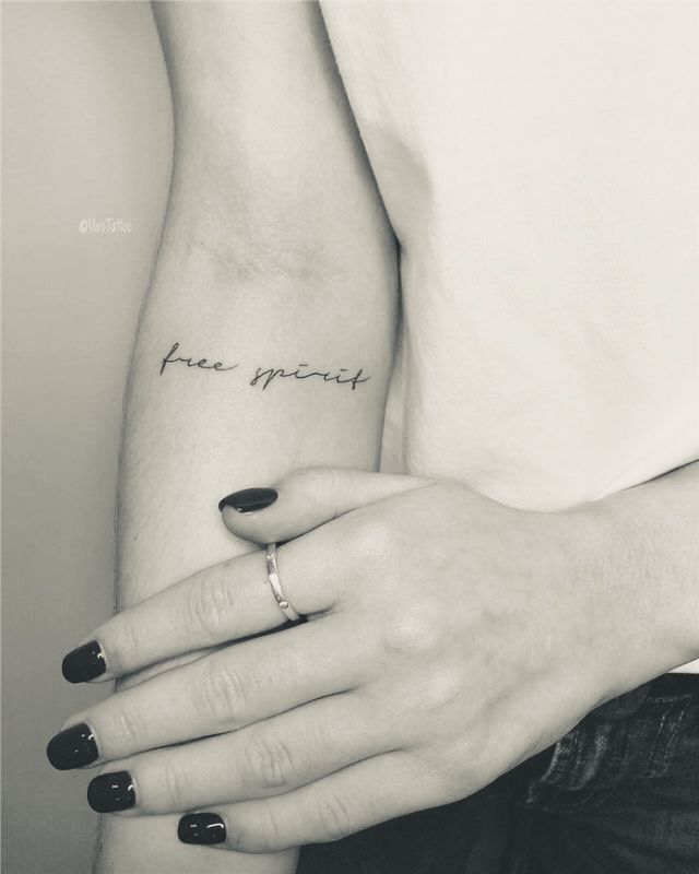 two hands holding each other with the words free speech tattooed on them, both in black and white