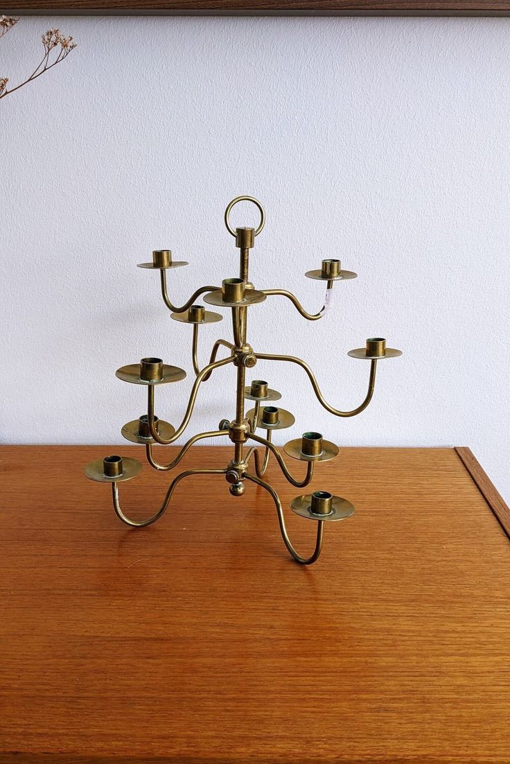 a brass candelabra on a wooden table