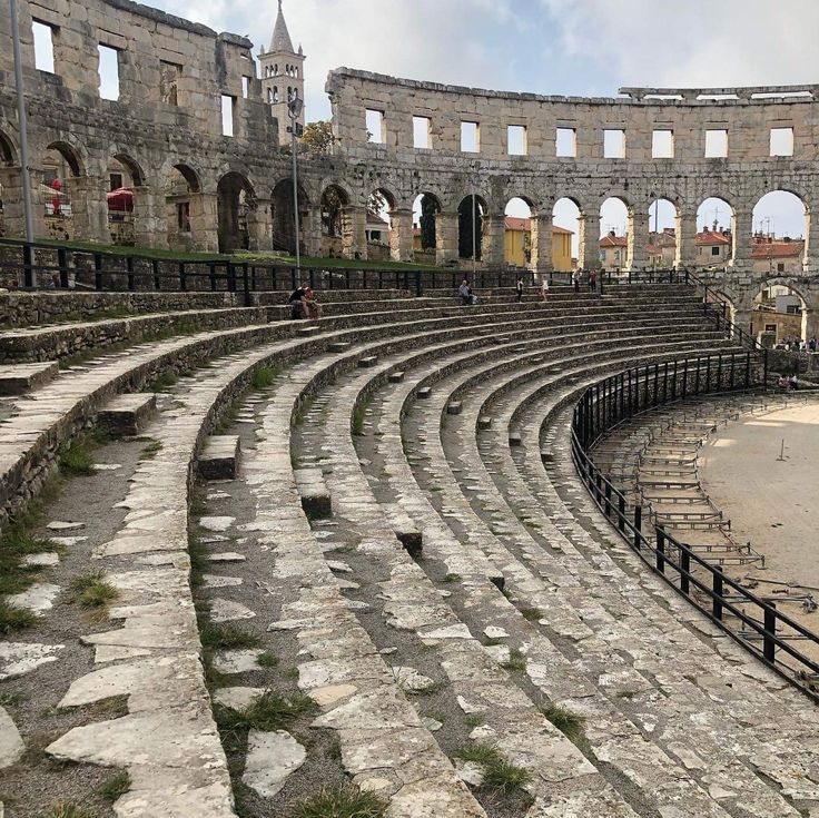 an old roman amphit with stone steps leading up to it