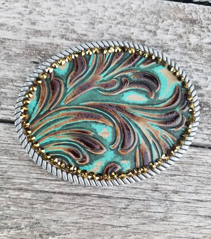 a brooch that is sitting on top of a wooden table