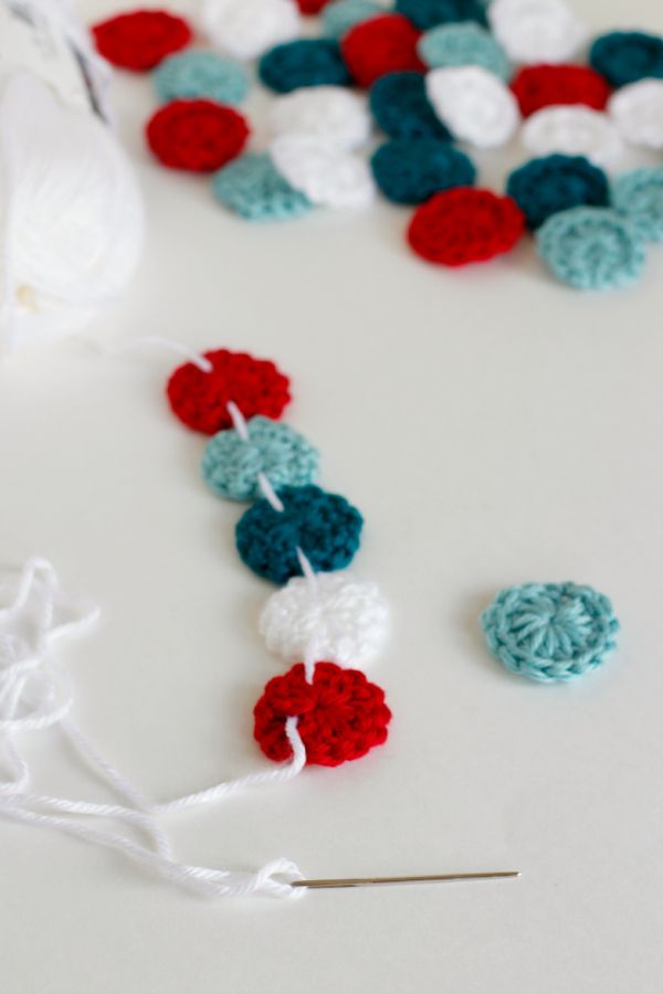 crocheted garland with red, white and blue balls hanging from it's end