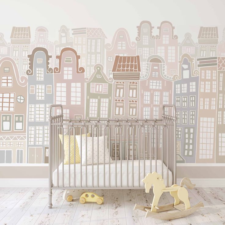 a baby's room with a crib, rocking horse and city wallpaper