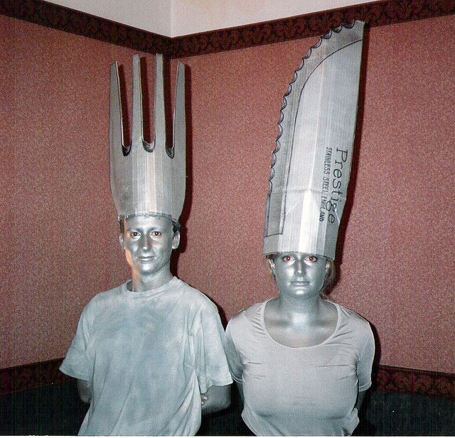 two mannequins with forks and knives on their heads