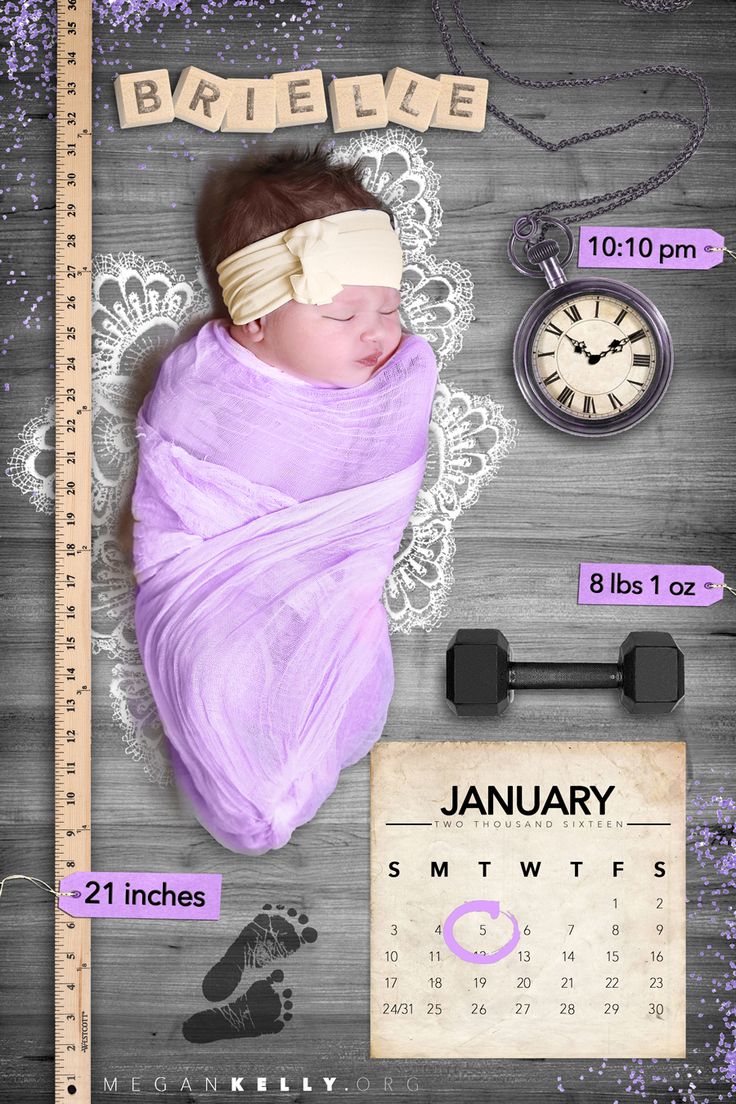 a baby wrapped in a blanket next to a clock