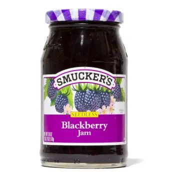 a jar of blackberry jam on a white background