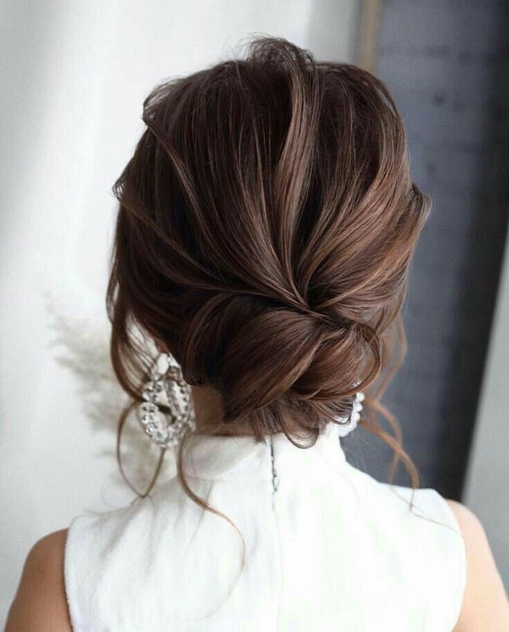 the back of a woman's head with her hair in a low bun