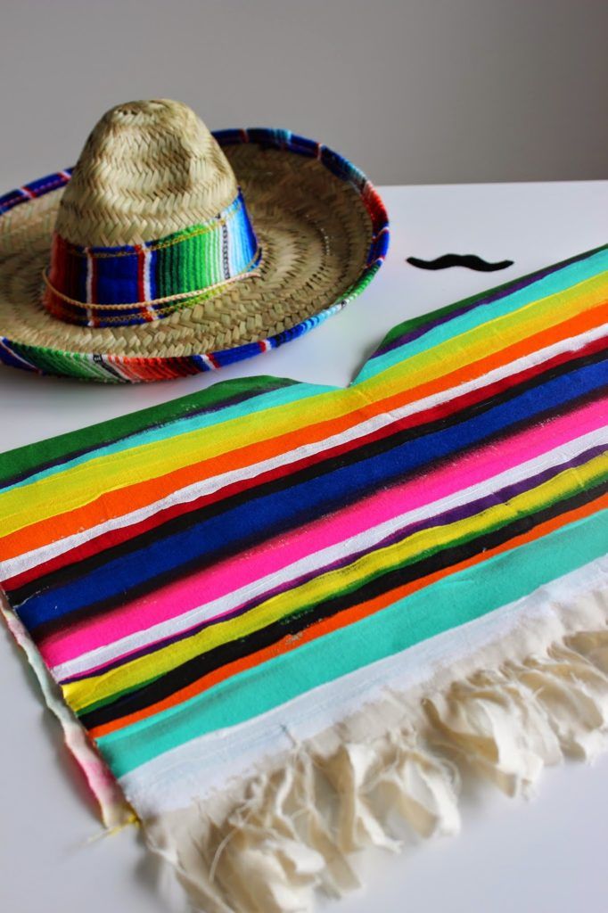 a mexican hat, scarf and sombrero on a table