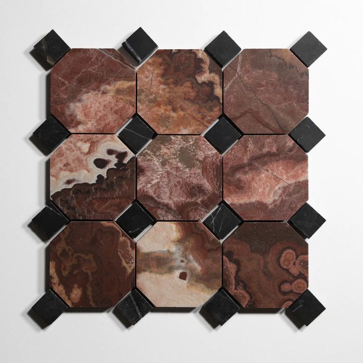 several different types of marble tiles on a white surface with black and brown designs in the middle