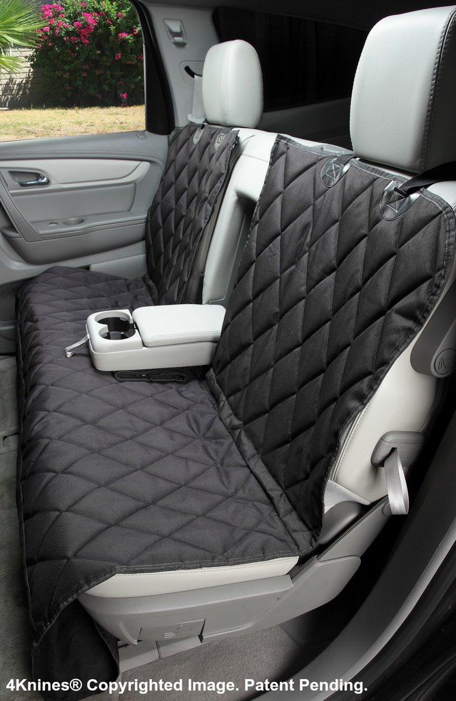 the interior of a car with two seats covered in black and white quilted material