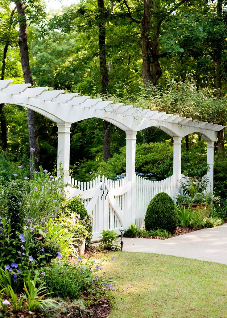 a white garden with lots of trees and bushes