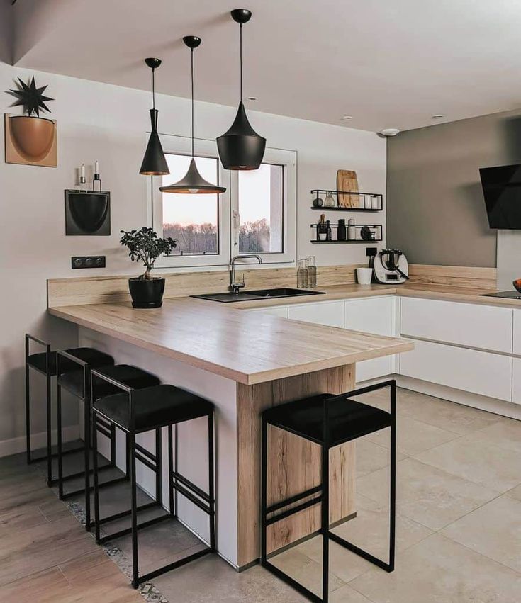 a kitchen island with stools in front of it