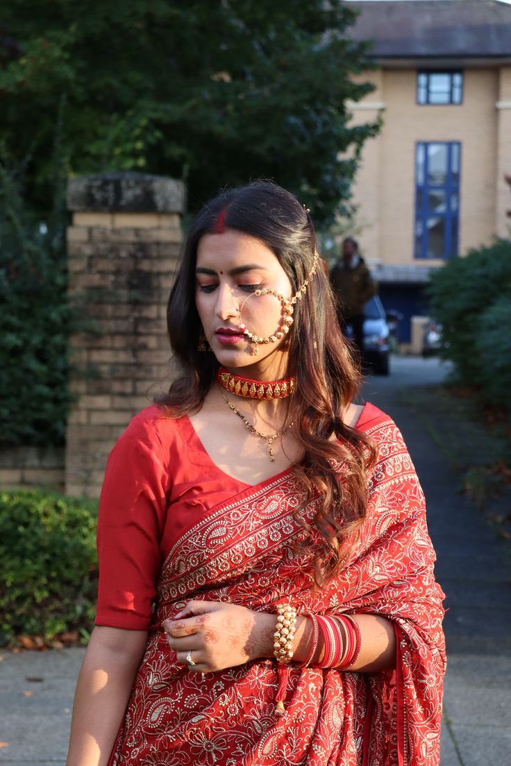 a woman in an orange and red sari