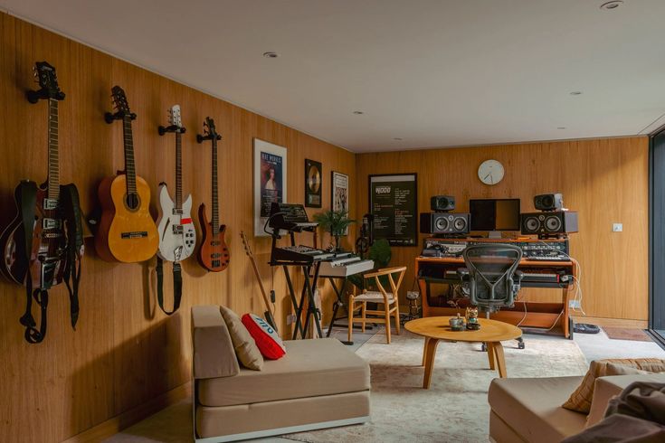 a living room with guitars on the wall