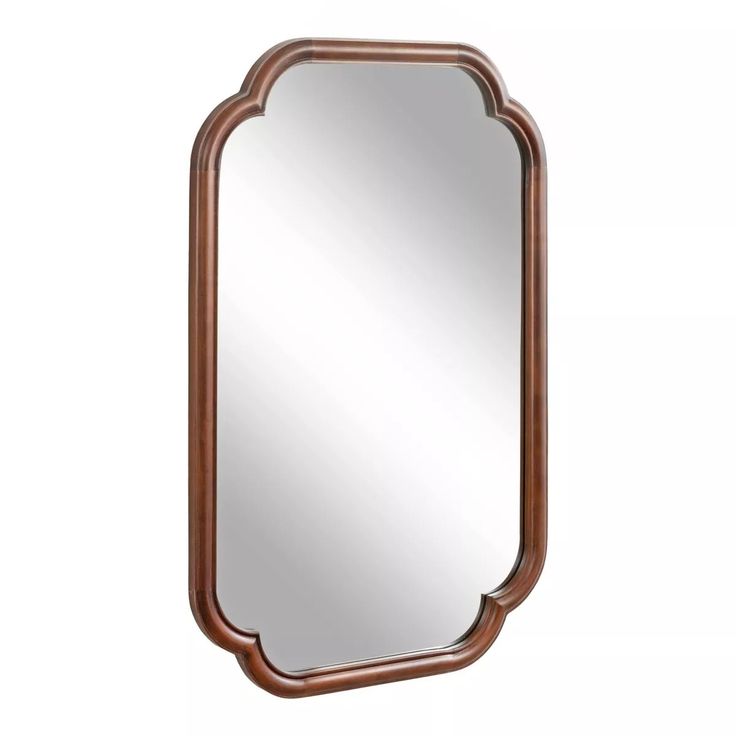 a mirror that is sitting on top of a wooden frame and has an arched edge