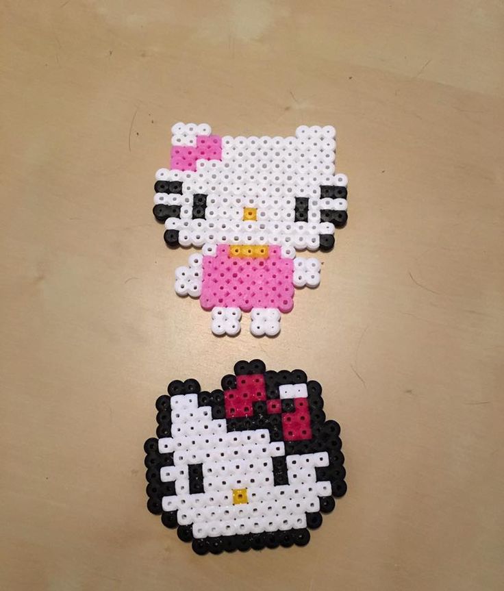 two hello kitty magnets made out of perler beads