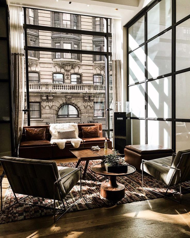 a living room filled with furniture and windows