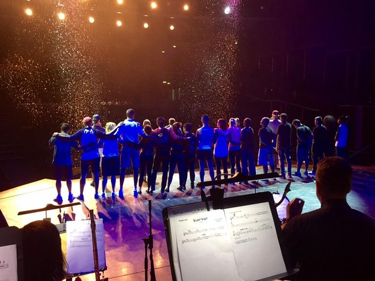 a group of people standing on top of a stage