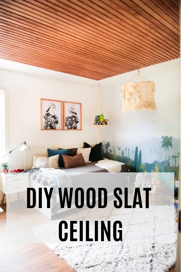 a living room with wood slat ceiling and white rug