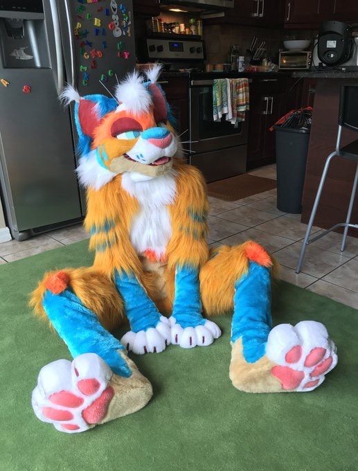 a large stuffed animal sitting on top of a green rug